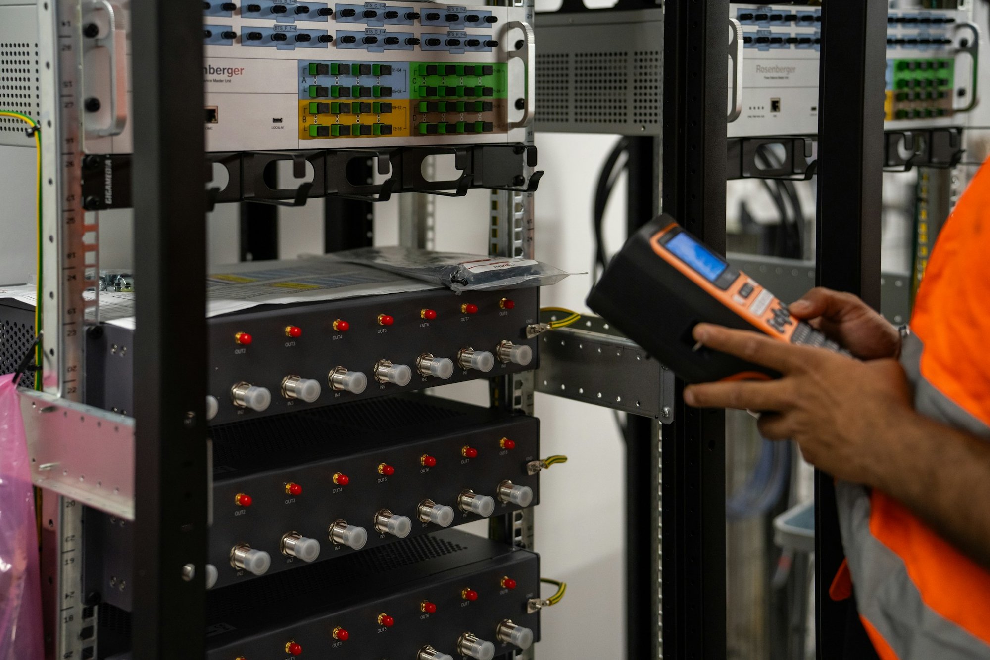 A technician checking equipment in a server rack