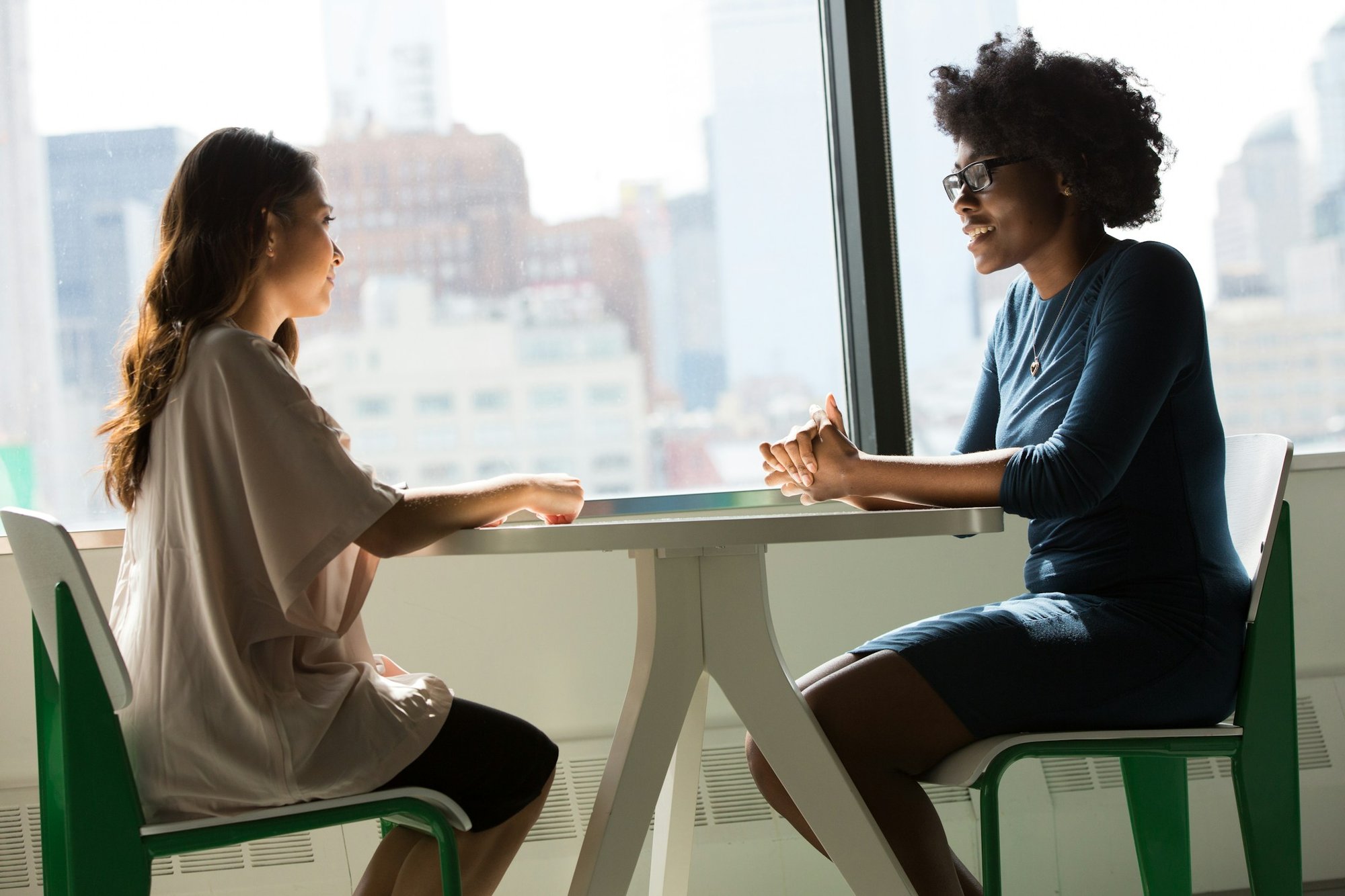 Two people talking at a table during an interview