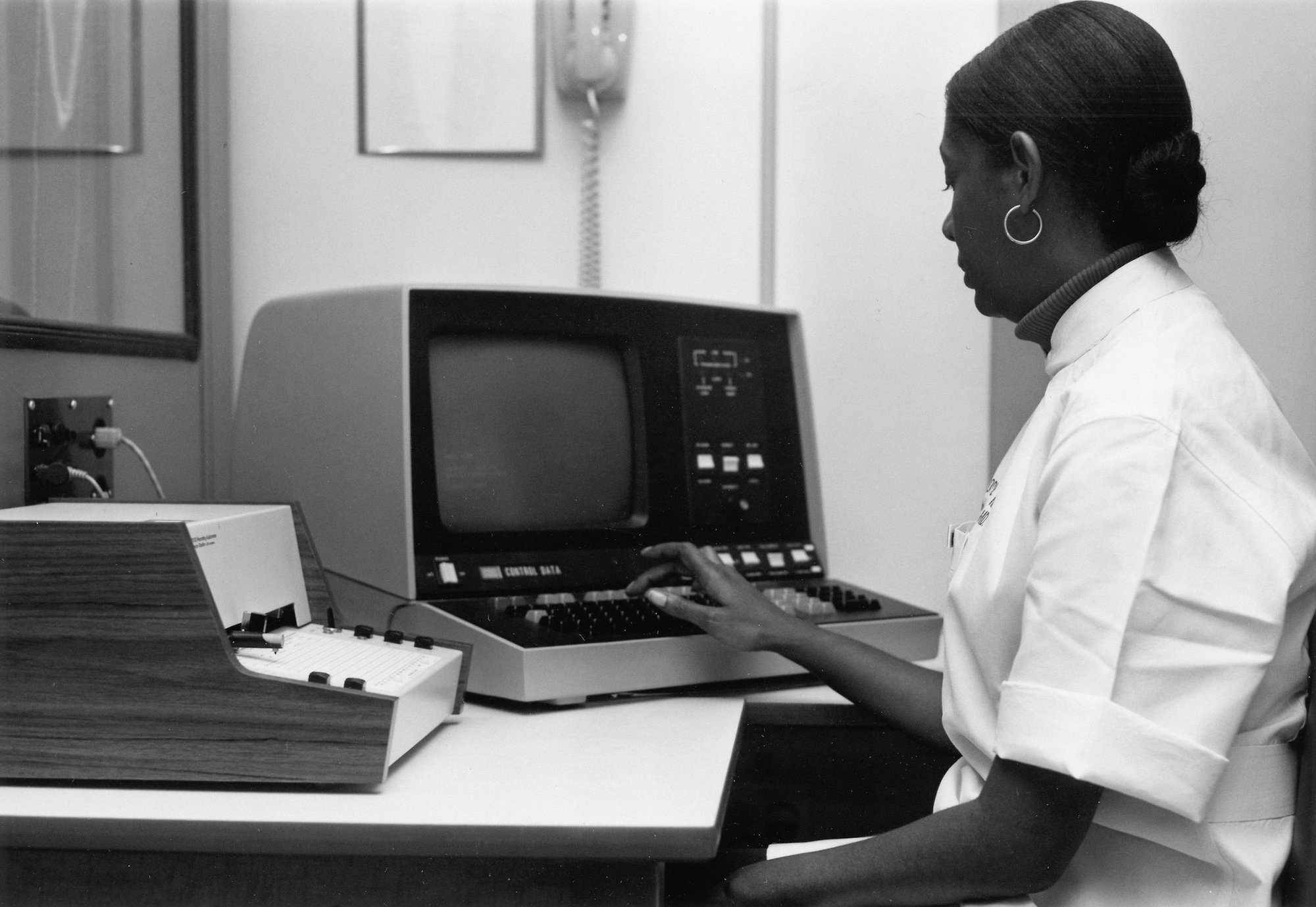 A woman working at an early computer terminal