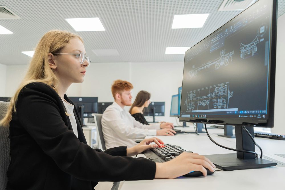 A researcher working at a computer in a lab office