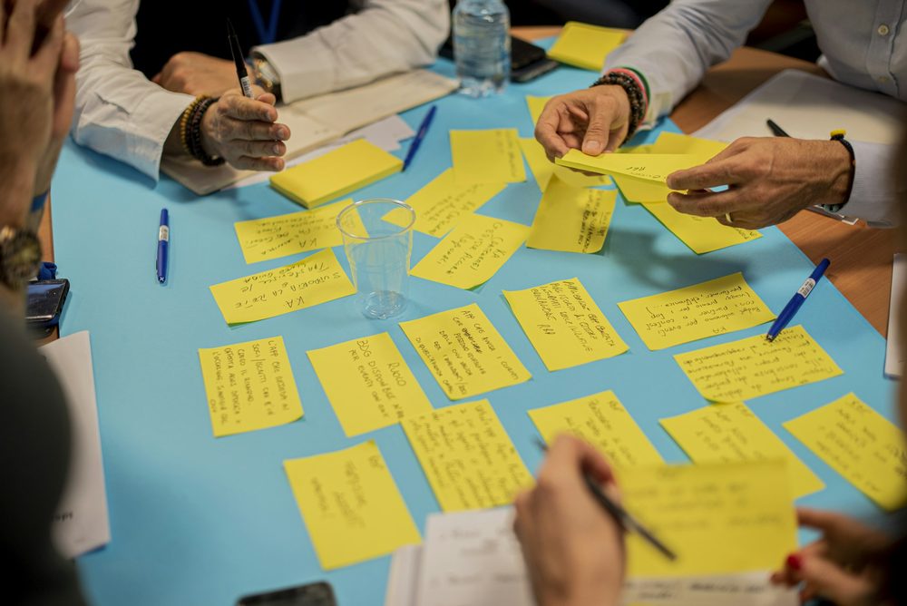 A team mapping a process with sticky notes on a table